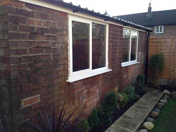 Brick Garage Refurbishment Refurbished Brick Garage with Two Large Windows