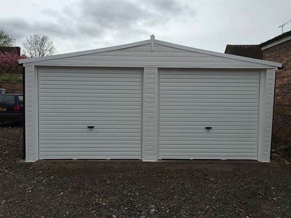 Double Garage with Doors and Cladding Double Garage Wrapped in uPVC Cladding in White