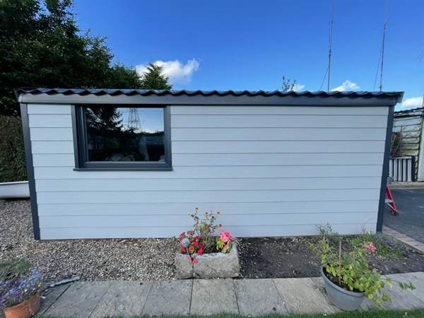 Concrete garage wrapped in composite cladding with Anthracite Grey Roof and Window